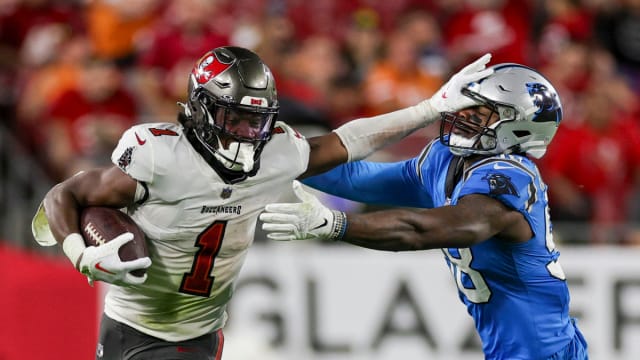 Dec 3, 2023; Tampa, Florida, USA; Tampa Bay Buccaneers running back Rachaad White (1) holds off Carolina Panthers linebacker Marquis Haynes Sr. (98) in the third quarter at Raymond James Stadium. Mandatory Credit: Nathan Ray Seebeck-USA TODAY Sports  